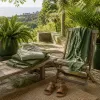 Resort wear without the tourist look: linen, leather sandals and the colors that read intentional